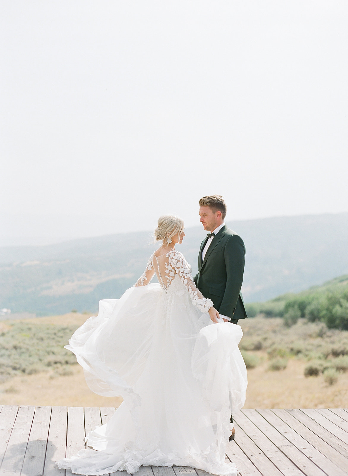 Groom with Real Bride Wearing 3-D Floral Lace Sheath Wedding Dress with Overskirt by Maggie Sottero