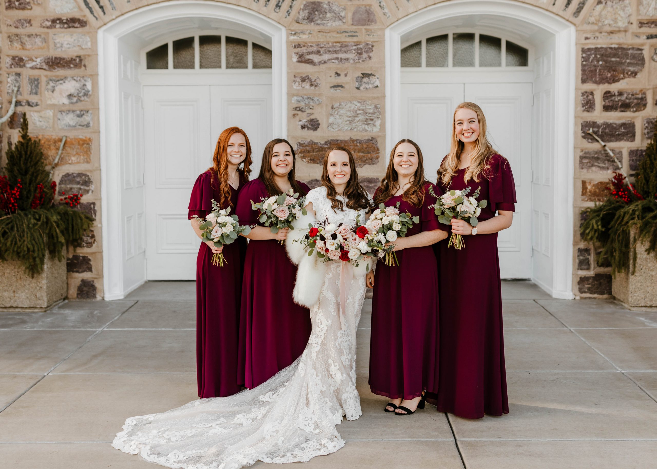 Real Bride Wearing Maggie Sottero Wedding Dress at Winter Wedding with Bridesmaids Wearing Berry Tone Dresses