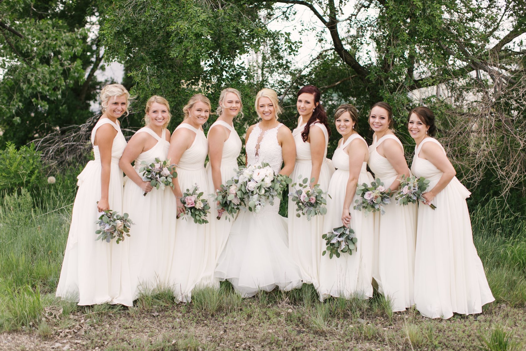 Real Bride Wearing Veda Wedding Dress with Bridesmaids Wearing White Dresses