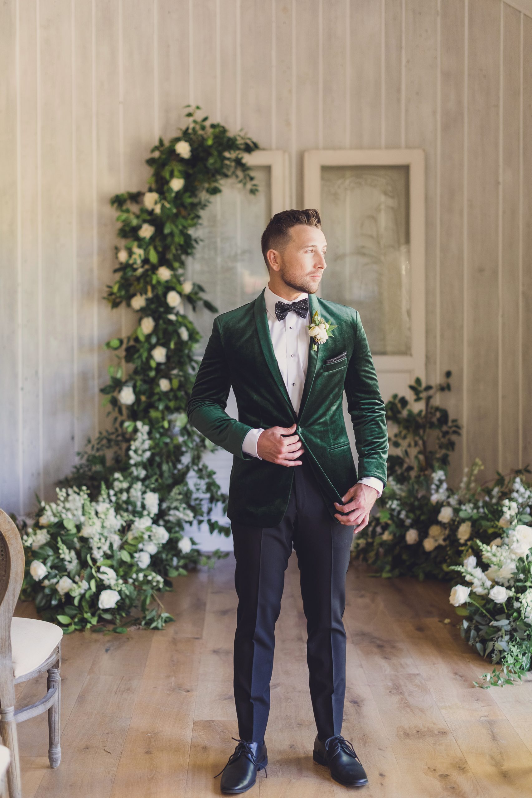 Groom wearing a green velvet suit jacket and black pants for a Luxe Spring Wedding