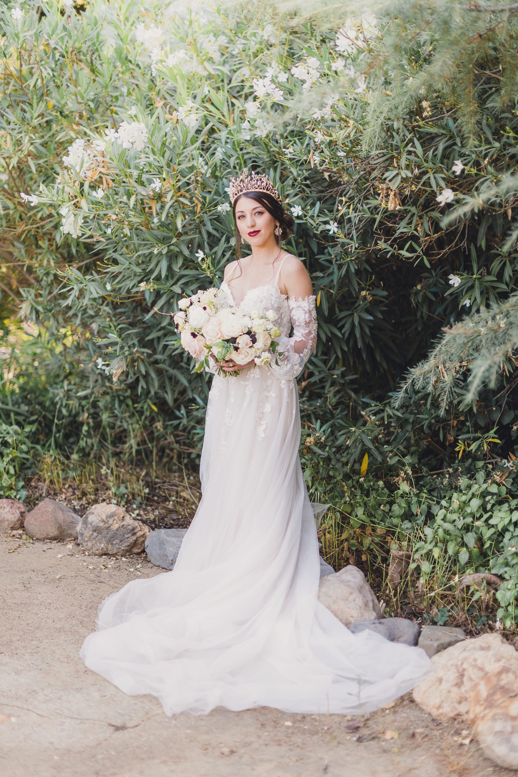 Model wearing Lace A-line Wedding Dress called Stevie by Maggie Sottero in a garden