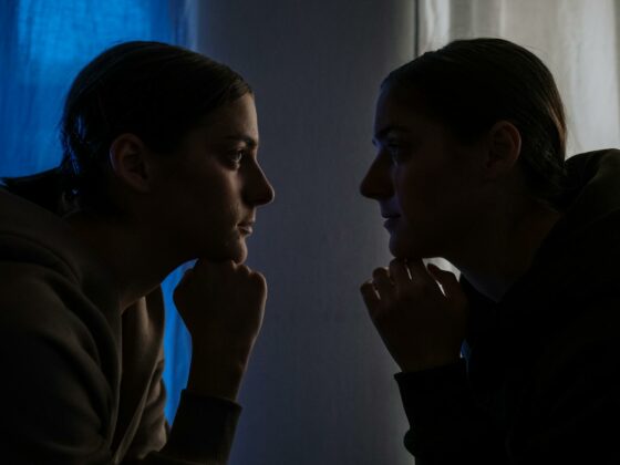 twins in dark looking at each other