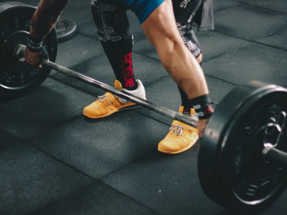 person about to start lifting the barbell inside the gym