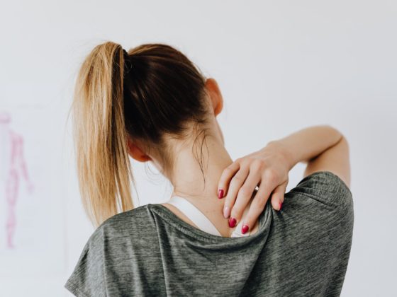 woman touching her back