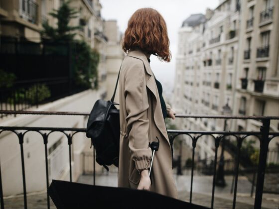 shallow focus photography of woman beside fence