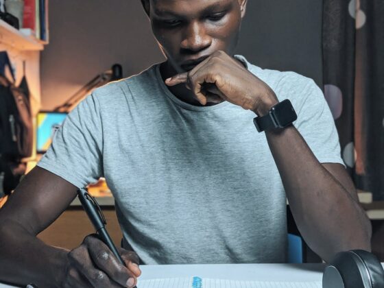 photo of man writing on notebook
