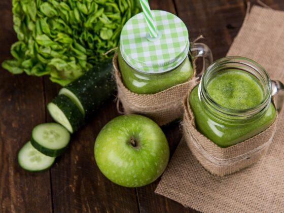 green apple beside of two clear glass jars