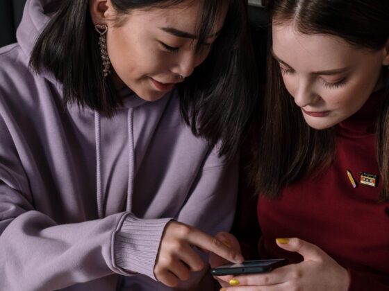close up shot of two teenagers looking at a smartphone