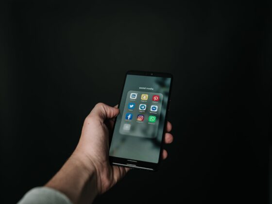 photo of hand holding a black smartphone