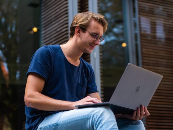 selective focus photo of man using laptop