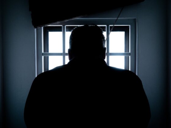 rear view of a silhouette man in window