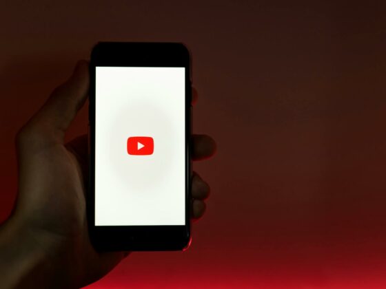 hand holding smartphone with internet access to youtube