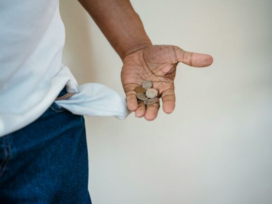 close up of man holding coins in hand