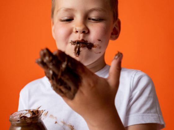 photo of boy enjoying melted chocolate