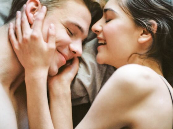 man and woman lying on bed