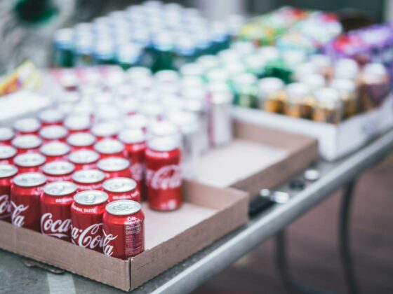 selective focus photography of red coca cola can lot on box