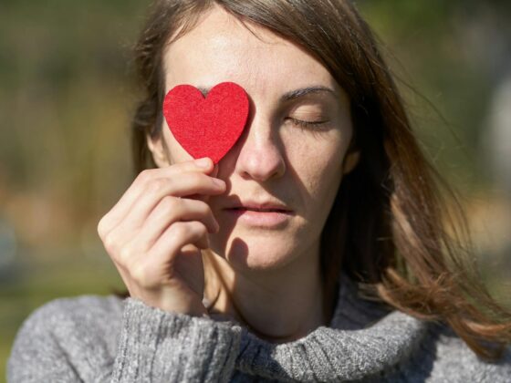 woman holding heart shaped cut out