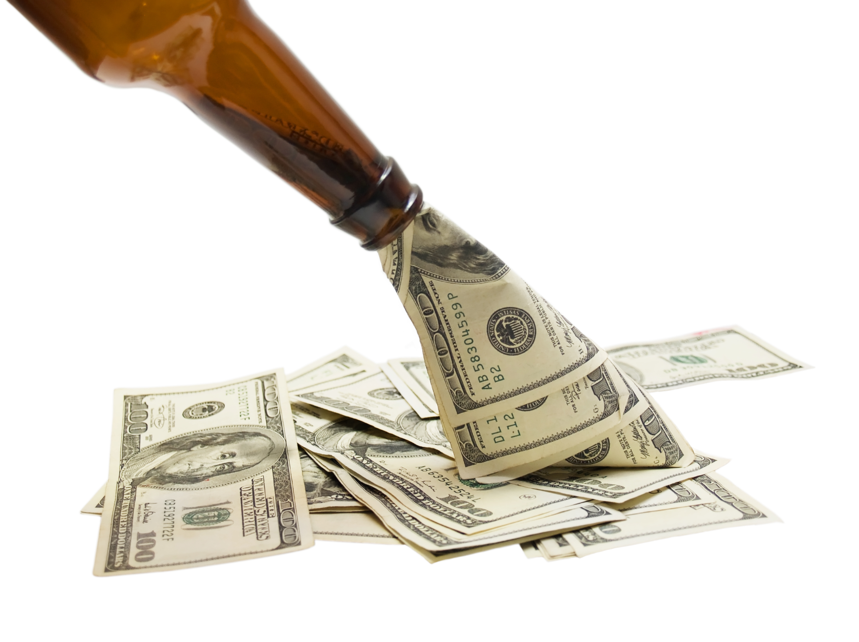 Cash being poured from a glass bottle, isolated on white.
